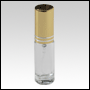 Clear glass, refillable bottle with golden metal  sprayer. Capacity: 5ml (1/6oz)